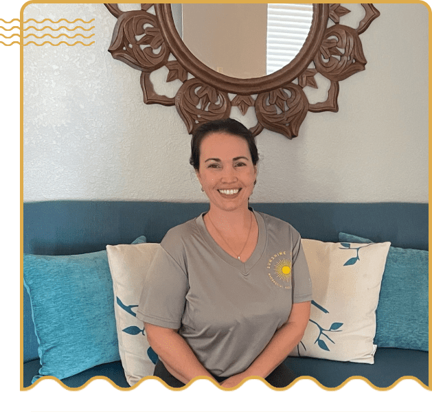 A woman sitting on top of a couch in front of a mirror.